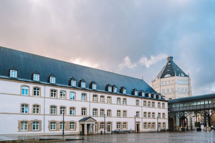Vista exterior de um edifício histórico de tribunal em Luxemburgo, sob céu nublado.